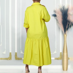 Detailed back view of a bright yellow shirt dress with large ruffled hem and flared design