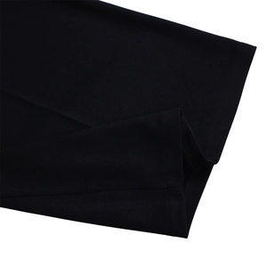 Detailed close-up of double-needle stitching on the black jumpsuit fabric edge
