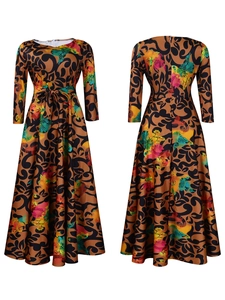 Detail of the colorful floral scroll print on a long-sleeved A-line maxi dress with waist tie