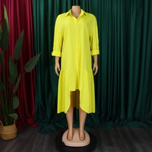 Detail of yellow high-low shirt dress with ruffle hem and adjustable long sleeves