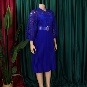 Detail of blue dress showing intricate lace crochet patterns and pleated skirt fabric texture