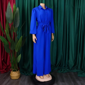 Detail view of royal blue long sleeve jumpsuit with buttoned lapel and waist tie belt