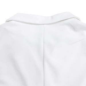 Detail of white sleeveless jumpsuit neckline showing premium stitching and woven texture