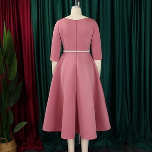 Detail of dusty pink dress back featuring a hidden zipper and pearl-beaded waist belt