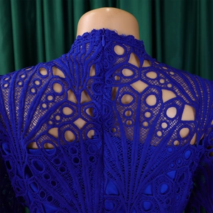 Detail of royal blue lace dress featuring hollow-out floral patterns and invisible back zipper