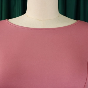 Close-up of pink knit dress round neckline showing detailed ribbed texture and double stitching