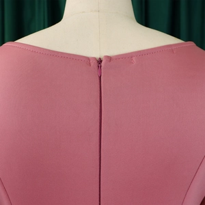 Detail view of the lotus pink off-shoulder dress featuring a discreet invisible back zipper