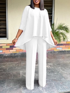 Women's chic white two-piece set with irregular tunic top and wide-leg trousers
