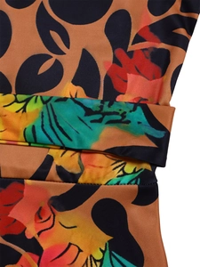 Detail of vibrant tropical floral print on elastic fabric with precise waist stitching
