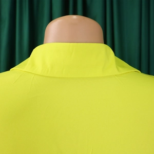 Detail of a fluorescent yellow loose shirt showing the collar and textured fabric back view