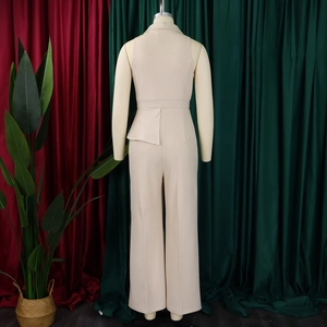 Detail view of beige sleeveless jumpsuit with blazer collar and wide-leg cut on mannequin