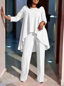 Chic white two-piece set featuring asymmetrical tunic top and wide-leg trousers for women