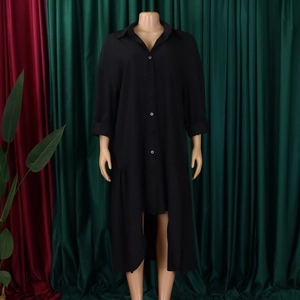 Detail of black long sleeve shirt dress featuring a classic collar and irregular high-low hem