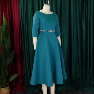 Detail of teal maxi dress with long sleeves and elegant pearl waist belt decoration