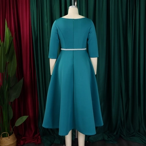 Detail view of dark teal evening dress featuring pearl waist belt and hidden back zipper