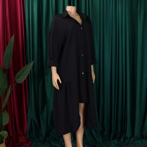 Detail view of black button-down shirt dress with asymmetrical hem and ruffled edge trim