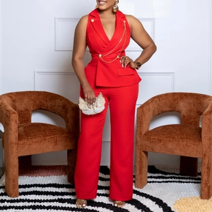 Detail of red sleeveless blazer jumpsuit with gold chain accents and wide leg pants