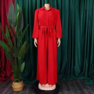 Detail view of red long-sleeve jumpsuit showing shirt collar and waist drawstring