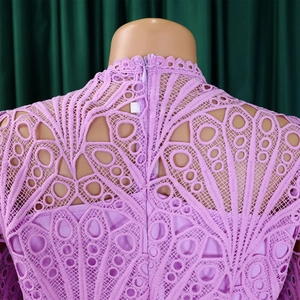 Detail of lavender lace dress showing intricate hollow embroidery and back zipper