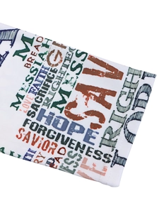 Close-up detail of the elegant floral dress featuring religious faith-themed letter printing