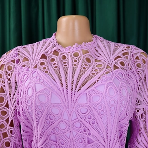 Detailed view of lavender purple lace dress with intricate floral crochet and hollow-out design