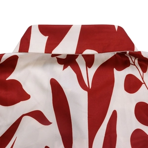 Détail de l'imprimé feuille rouge sur la chemise en satin blanc avec coutures premium