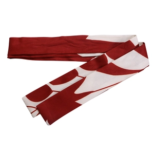 Détail d'une ceinture en tissu à motif ethnique rouge et blanc avec vagues abstraites
