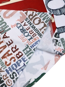 Detail of double-needle hem stitching and inspirational text print on dress fabric