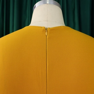 Détail du dos de la robe jaune moutarde avec une fermeture éclair invisible assortie au tissu