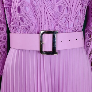 Detail of purple lace crochet bodice with pleated skirt and metallic D-ring belt buckle