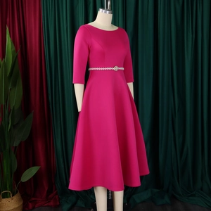 Detail of rose pink formal dress with pleated skirt and pearl rhinestone belt