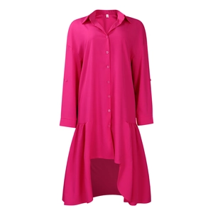 Detail of rose red shirt dress featuring high-low ruffled hem and button-down front closure