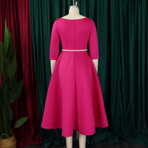 Macro view of rose red evening dress featuring a pearl belt and hidden back zipper