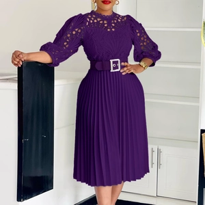 Detailed view of dark purple dress featuring lace cut-outs and pleated accordion skirt fabric
