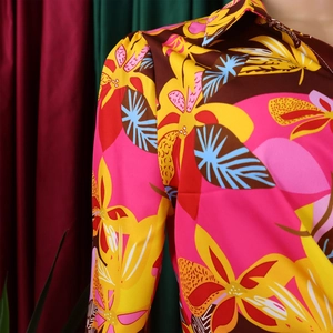 Détail de l'imprimé floral tropical vintage sur tissu satiné soyeux avec col à revers
