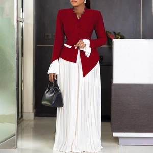 Detail of burgundy blazer with white ruffle sleeves and pleated wide-leg pants for women