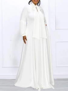 Elegant white maxi dress with long puff sleeves and a high-waisted flowing skirt