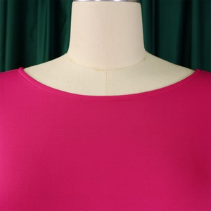 Detailed close-up of the neat neckline stitching on a rose red evening dress