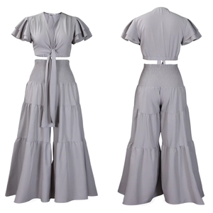 Détail d'un ensemble deux pièces gris-violet avec haut à nouer et pantalon large à volants