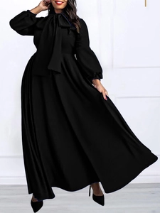 Elegant black long-sleeve maxi dress with pussy-bow neck and high waist pleats