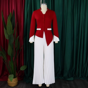 Detail of red flare sleeve top with white pleated trim and matching wide-leg trousers