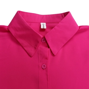 Detail of rose pink dress showing lapel collar, matching buttons, and woven fabric texture