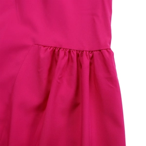 Detail of rose pink dress showing high-quality stitching and pleated fabric texture