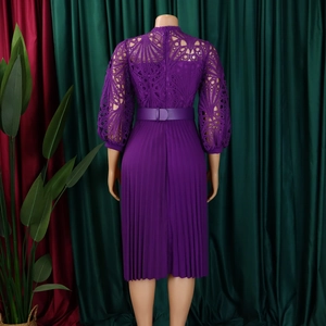 Detail of purple dress featuring intricate lace hollow-out design and pleated skirt