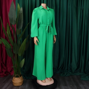 Detail of bright green long sleeve jumpsuit with shirt collar and waist tie detail