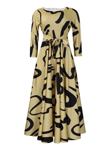 Detail of elegant long sleeve dress with black abstract print and waist tie belt