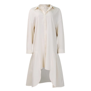 Detail of the asymmetrical hemline and smooth woven fabric on this cream shirt dress