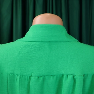 Macro shot of back neckline pleated detail on bright green cotton linen jumpsuit