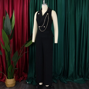 Detail of elegant black sleeveless jumpsuit featuring gold waist chains and buttons