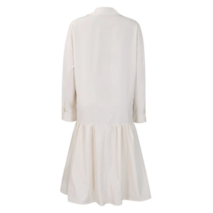 Back view detail of beige long sleeve dress with ruffle hem and classic shirt collar